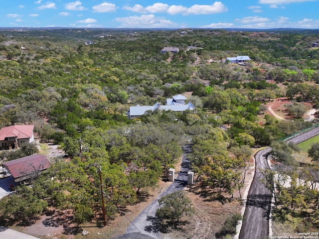 aerial view featuring a wooded view