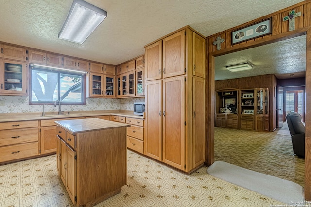 kitchen with light countertops, a sink, and light floors