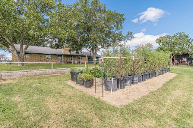 view of yard with a garden and fence
