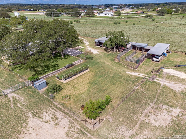 birds eye view of property with a rural view