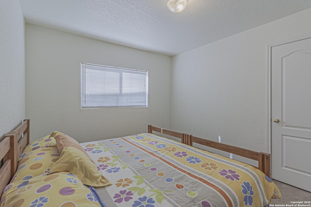 4907 Heather Pass, San Antonio, TX 78218 - bedroom featuring carpet floors, a textured wall, and a textured ceiling