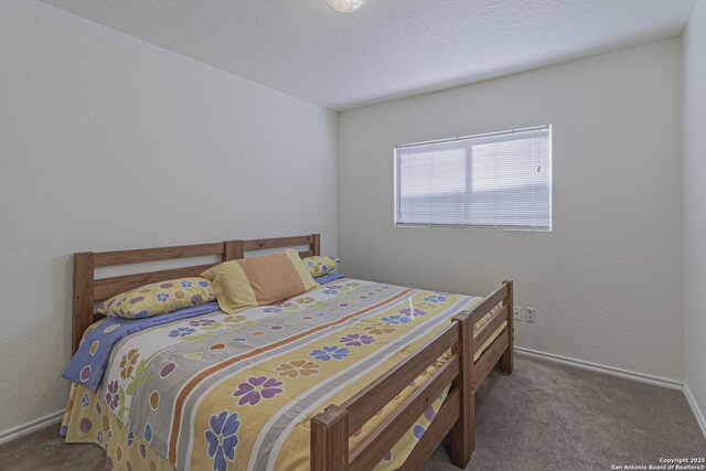 4907 Heather Pass, San Antonio, TX 78218 - carpeted bedroom with baseboards, a textured ceiling, and a textured wall