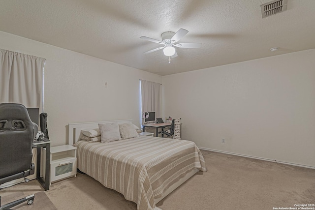 4907 Heather Pass, San Antonio, TX 78218 - bedroom featuring a textured ceiling, baseboards, light colored carpet, visible vents, and ceiling fan