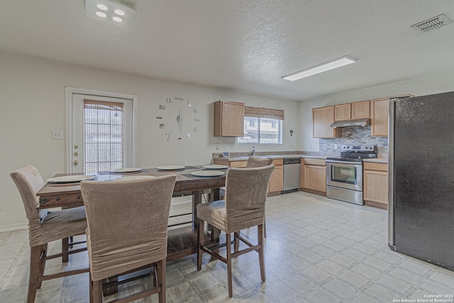 4907 Heather Pass, San Antonio, TX 78218 - dining area with a textured ceiling, visible vents, and light floors