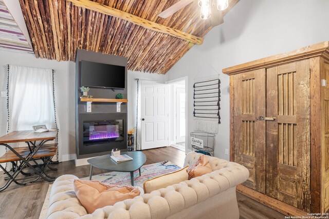 608 W Morse St, Fredericksburg, TX 78624 - living room with a glass covered fireplace, wood finished floors, ceiling fan, baseboards, and wooden ceiling