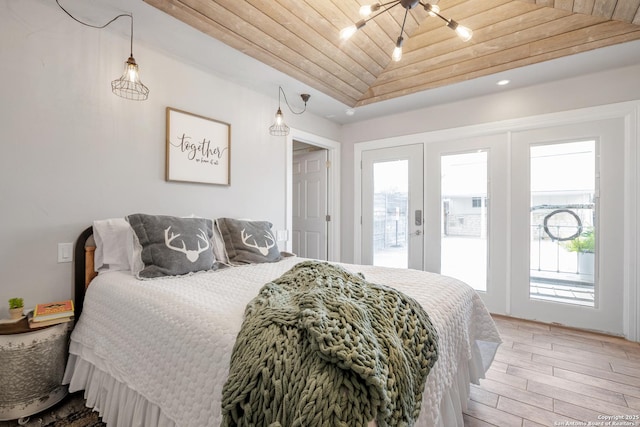 608 W Morse St, Fredericksburg, TX 78624 - bedroom featuring access to outside, wood finished floors, wood ceiling, and a chandelier