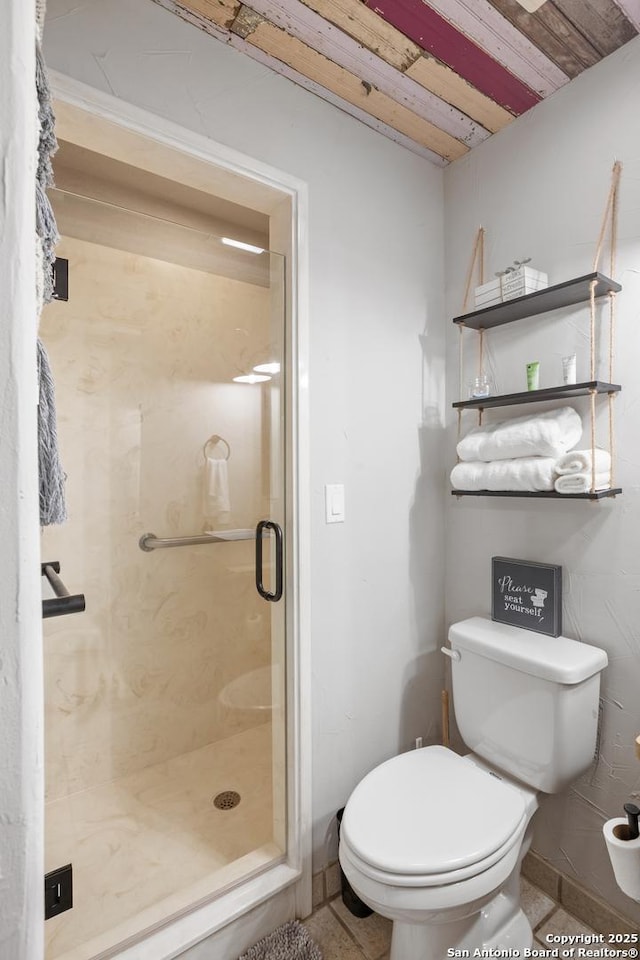608 W Morse St, Fredericksburg, TX 78624 - bathroom with toilet, a stall shower, tile patterned flooring, and wood ceiling