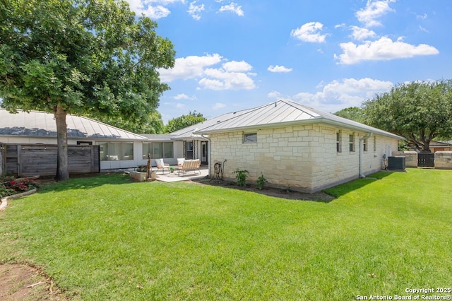 608 W Morse St, Fredericksburg, TX 78624 - back of property featuring central air condition unit, a patio, a standing seam roof, stone siding, and metal roof