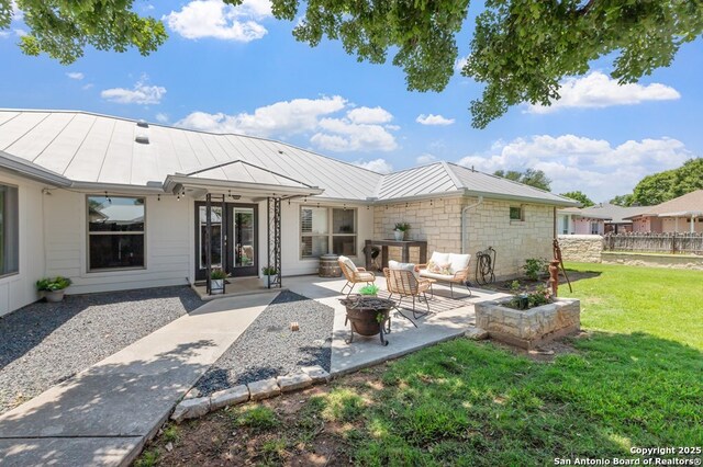 608 W Morse St, Fredericksburg, TX 78624 - back of house with an outdoor fire pit, a standing seam roof, a patio, metal roof, and french doors