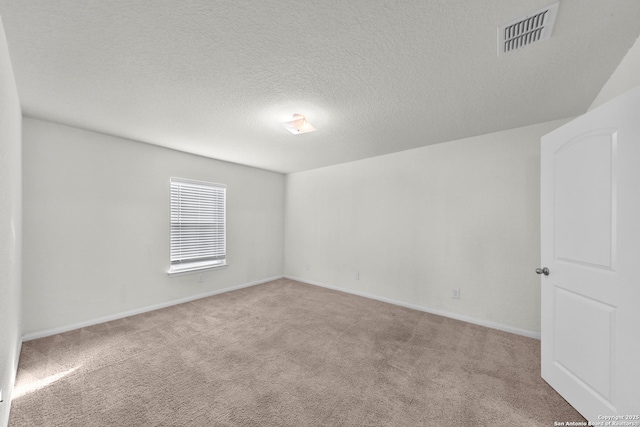 12266 Stratsburg, San Antonio, TX 78252 - spare room featuring baseboards, carpet floors, a textured ceiling, and visible vents