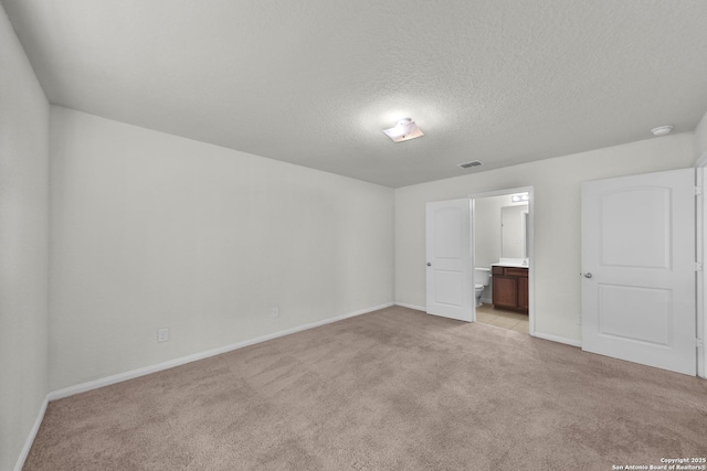 12266 Stratsburg, San Antonio, TX 78252 - unfurnished bedroom with light colored carpet, baseboards, a textured ceiling, visible vents, and ensuite bathroom