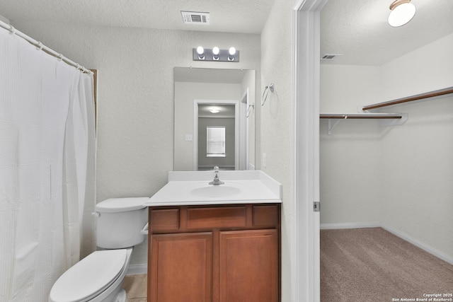 12266 Stratsburg, San Antonio, TX 78252 - bathroom with toilet, a textured wall, a textured ceiling, and visible vents