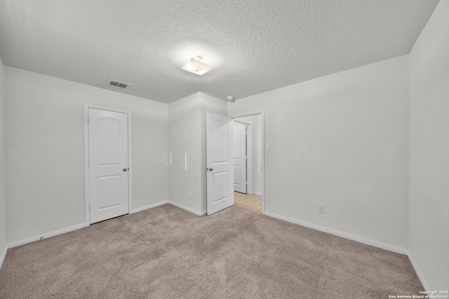 12266 Stratsburg, San Antonio, TX 78252 - empty room with baseboards, a textured ceiling, visible vents, and light carpet