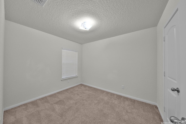 12266 Stratsburg, San Antonio, TX 78252 - spare room with carpet flooring, baseboards, and a textured ceiling