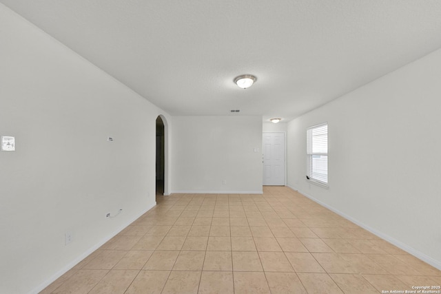 12266 Stratsburg, San Antonio, TX 78252 - unfurnished room with baseboards, visible vents, arched walkways, and light tile patterned floors