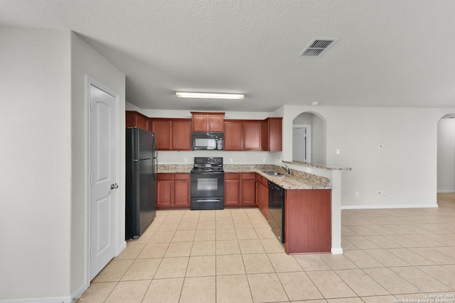 12266 Stratsburg, San Antonio, TX 78252 - kitchen with a sink, a peninsula, visible vents, black appliances, and arched walkways