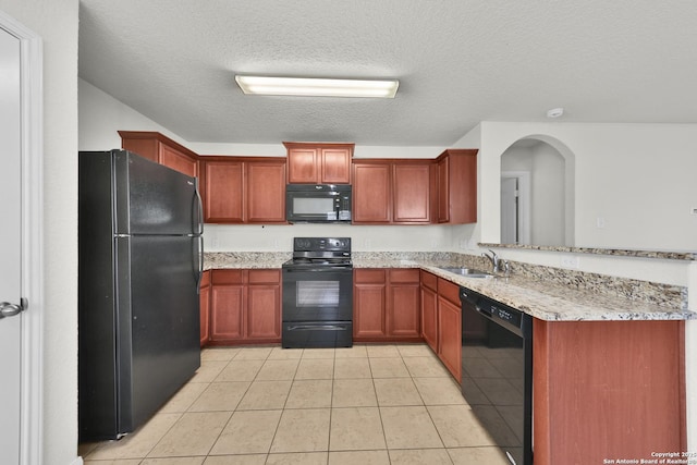 12266 Stratsburg, San Antonio, TX 78252 - kitchen featuring a peninsula, light stone countertops, a sink, black appliances, and light tile patterned floors