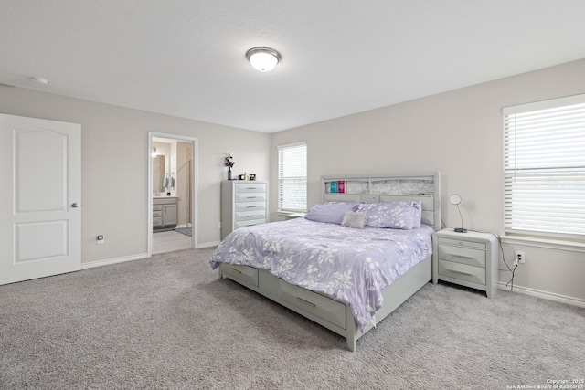 1623 Iron Crk, San Antonio, TX 78245 - bedroom featuring baseboards, connected bathroom, and light carpet