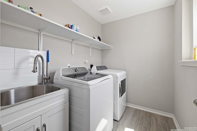1623 Iron Crk, San Antonio, TX 78245 - clothes washing area featuring a sink, baseboards, independent washer and dryer, visible vents, and cabinet space