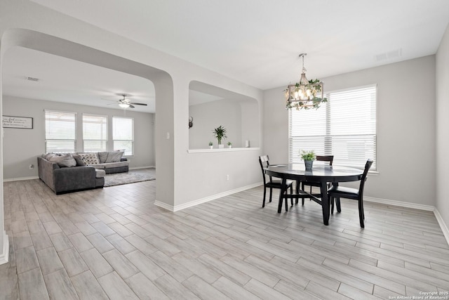 1623 Iron Crk, San Antonio, TX 78245 - dining space with ceiling fan with notable chandelier, visible vents, light wood-style flooring, and baseboards
