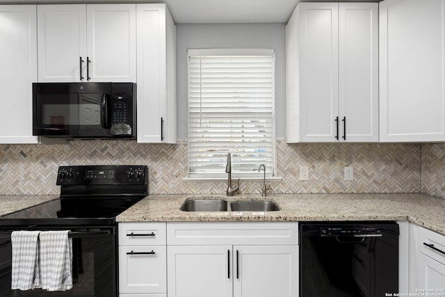 kitchen featuring white cabinets, a sink, and black appliances