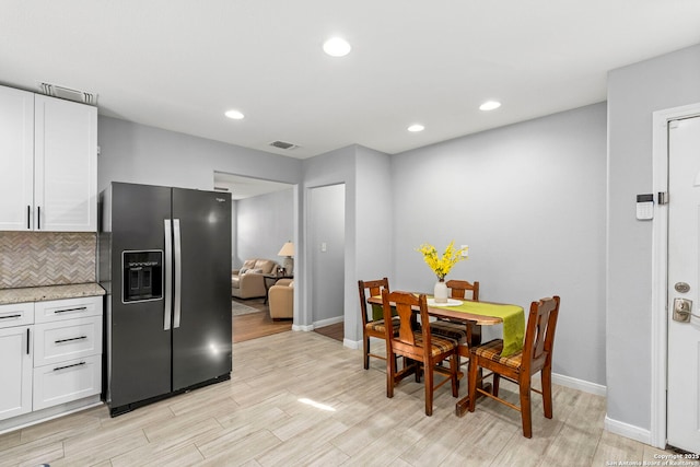 dining area with recessed lighting, baseboards, light wood finished floors, and visible vents