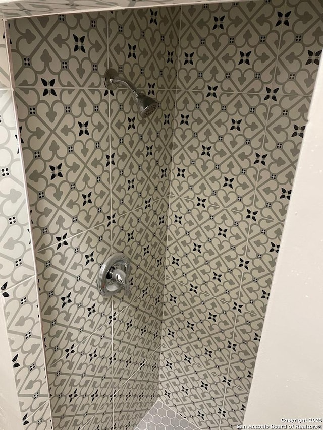 bathroom with tiled shower