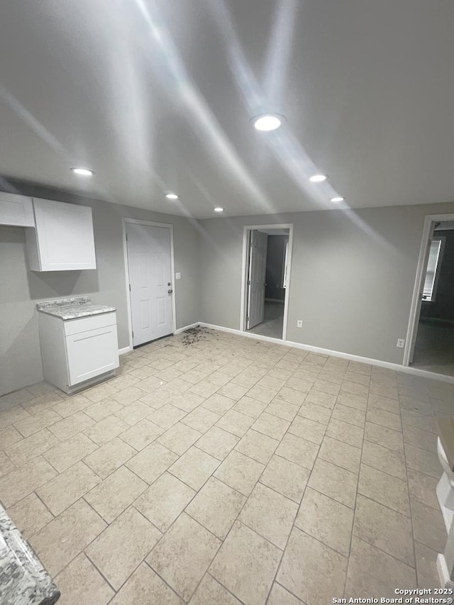 unfurnished living room featuring baseboards and recessed lighting