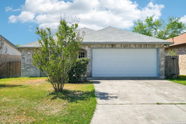 single story home featuring fence, a front yard, an attached garage, and concrete driveway