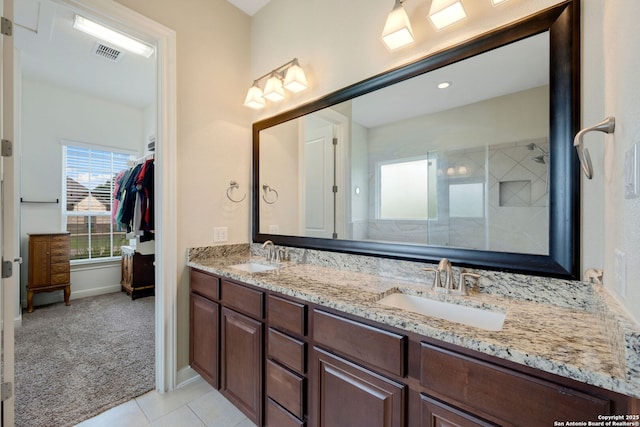 146 Sunrise Hl, Castroville, TX 78009 - bathroom with tile patterned floors, double vanity, visible vents, and a sink