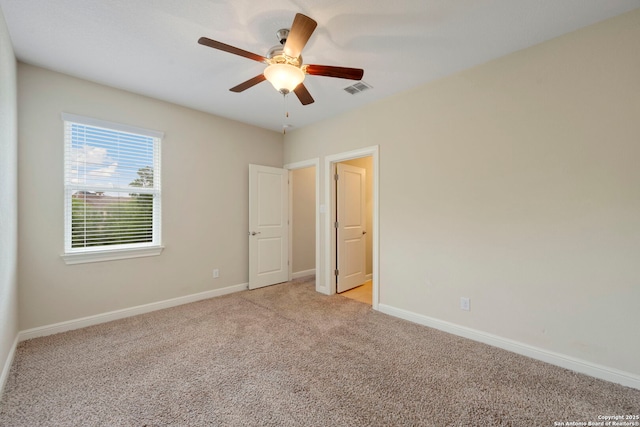 146 Sunrise Hl, Castroville, TX 78009 - unfurnished bedroom with visible vents, baseboards, a ceiling fan, and light carpet