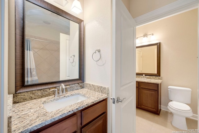 146 Sunrise Hl, Castroville, TX 78009 - bathroom featuring a sink, toilet, two vanities, and tile patterned floors