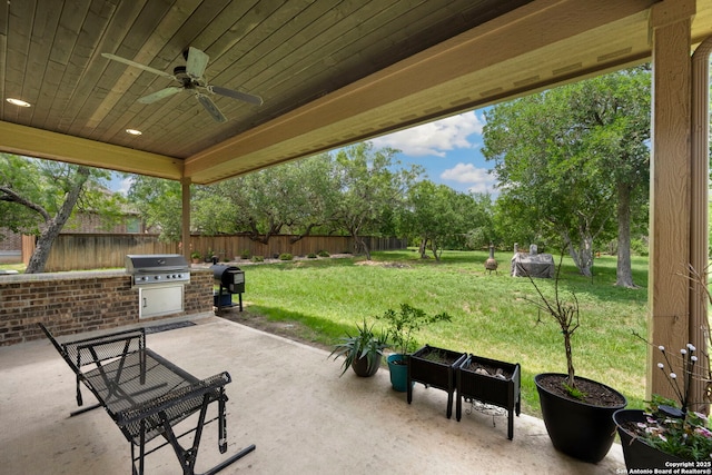 146 Sunrise Hl, Castroville, TX 78009 - view of patio / terrace featuring exterior kitchen, area for grilling, ceiling fan, and a fenced backyard