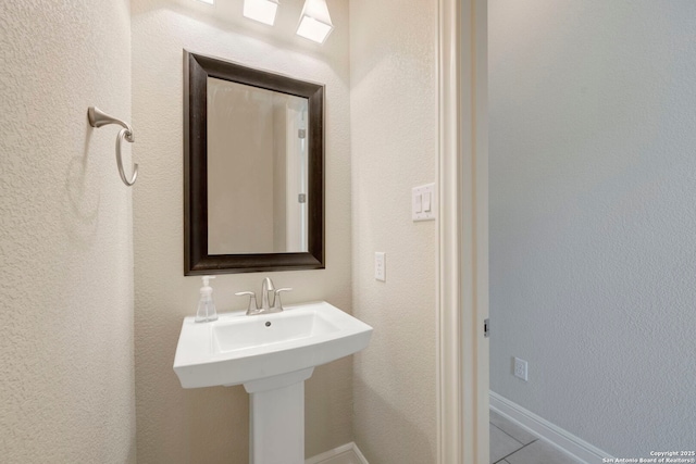 146 Sunrise Hl, Castroville, TX 78009 - bathroom with baseboards and tile patterned floors