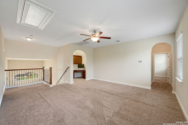 146 Sunrise Hl, Castroville, TX 78009 - unfurnished room with attic access, a healthy amount of sunlight, a ceiling fan, and arched walkways