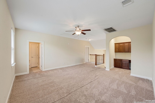 146 Sunrise Hl, Castroville, TX 78009 - unfurnished living room with light carpet, baseboards, a ceiling fan, and visible vents