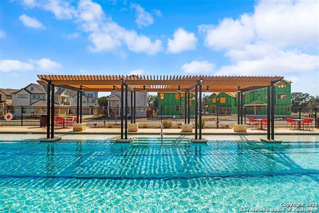9623 Van Horn, San Antonio, TX 78254 - view of swimming pool featuring fence, a pergola, and a residential view