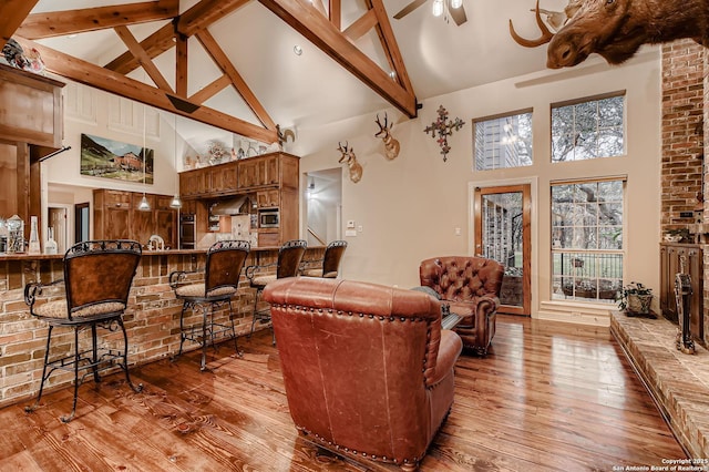409 Sandy Oaks, Boerne, TX 78015 - living area featuring ceiling fan, high vaulted ceiling, beamed ceiling, and hardwood / wood-style flooring