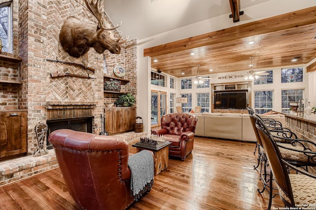 409 Sandy Oaks, Boerne, TX 78015 - living room featuring beamed ceiling, a fireplace, ceiling fan, hardwood / wood-style floors, and wood ceiling