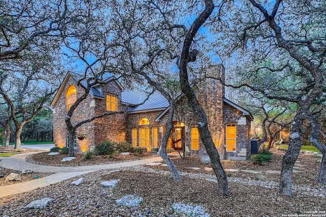 409 Sandy Oaks, Boerne, TX 78015 - traditional-style house featuring a standing seam roof, a chimney, stone siding, and metal roof