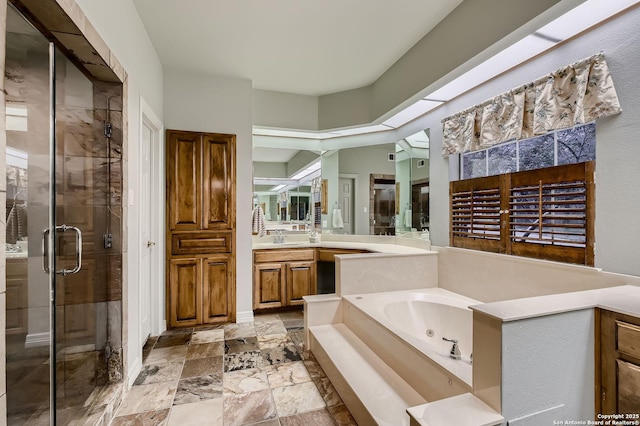 409 Sandy Oaks, Boerne, TX 78015 - full bath with a stall shower, stone tile flooring, vanity, and a jetted tub