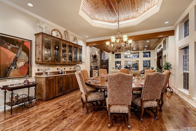 409 Sandy Oaks, Boerne, TX 78015 - dining space with a tray ceiling, crown molding, wood ceiling, wood finished floors, and an inviting chandelier