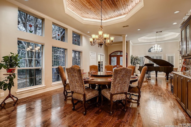 409 Sandy Oaks, Boerne, TX 78015 - dining space featuring wood-type flooring, ornamental molding, an inviting chandelier, and a raised ceiling