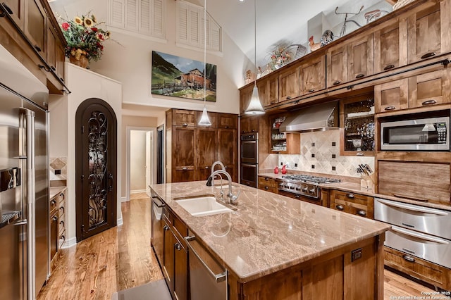 409 Sandy Oaks, Boerne, TX 78015 - kitchen featuring a sink, a warming drawer, wall chimney range hood, and appliances with stainless steel finishes