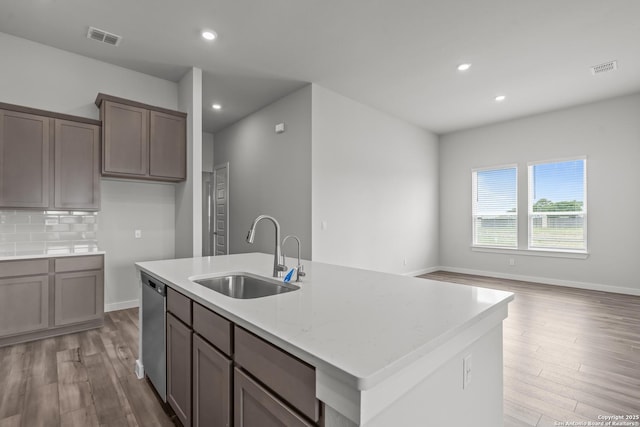 1509 Passmore Downs, New Braunfels, TX 78130 - kitchen with a sink, light wood-style flooring, dishwasher, a kitchen island with sink, and recessed lighting