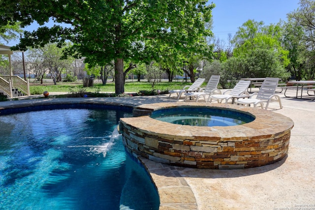 view of pool featuring a patio area and a pool with connected hot tub