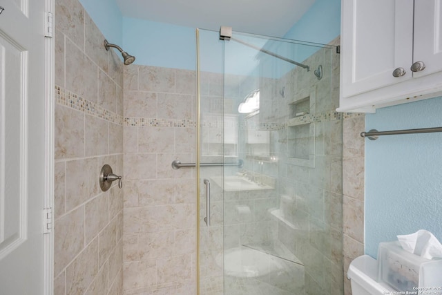 full bath with a shower stall and toilet