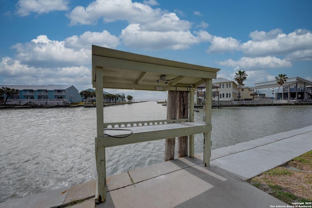 view of dock with a residential view and a water view