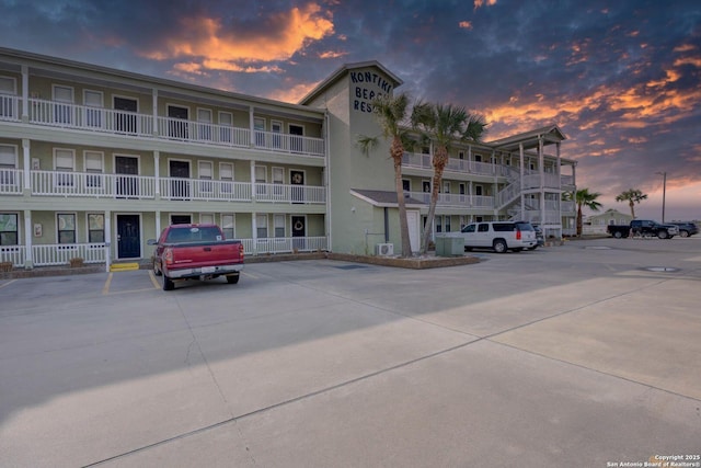 property at dusk with uncovered parking