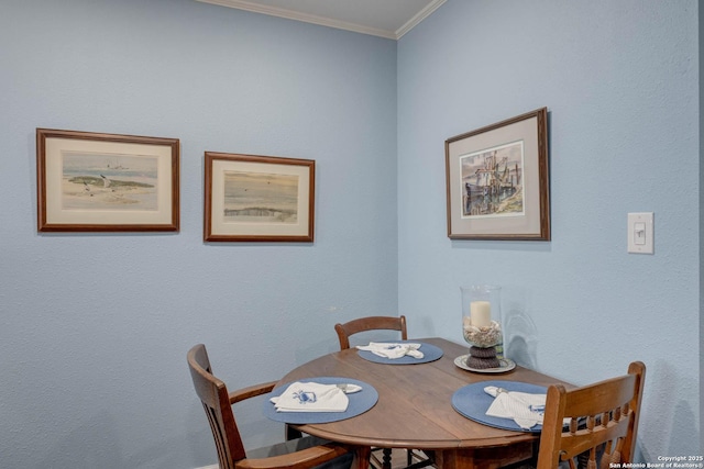 dining area featuring crown molding